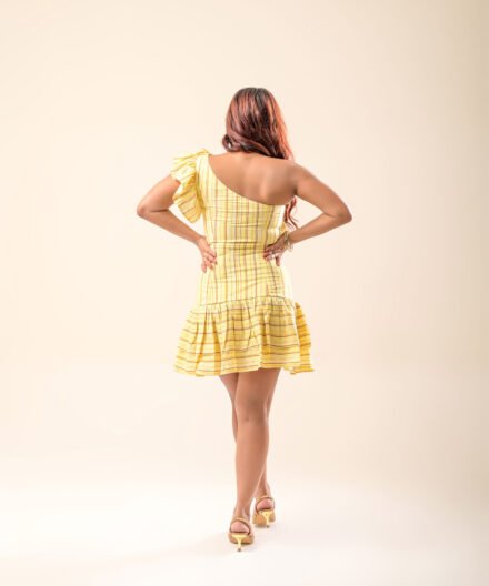 Back view of the striped one-shoulder ruffle mini dress, showcasing the fitted silhouette and side zip closure.