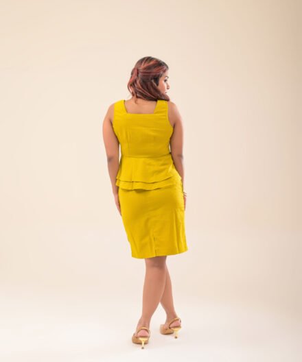 Back view of sleeveless peplum crop top and mini skirt