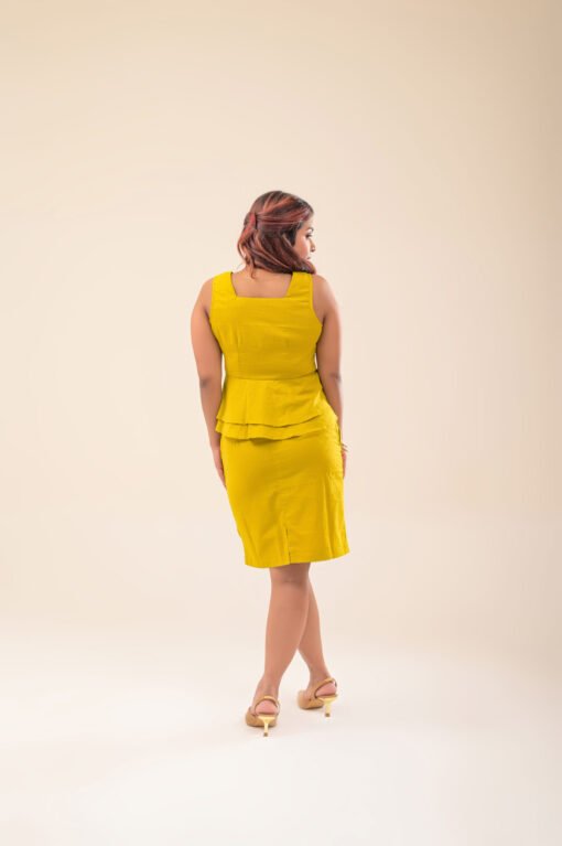 Back view of sleeveless peplum crop top and mini skirt