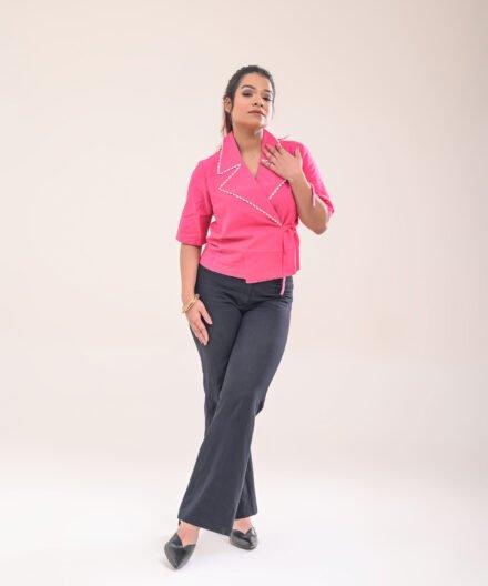 Full-length front view of the wrap shirt, paired with high-waisted pants.
