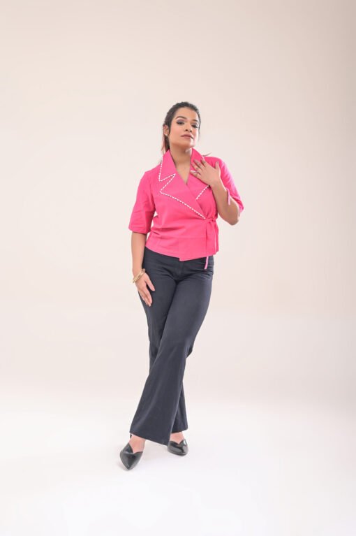 Full-length front view of the wrap shirt, paired with high-waisted pants.