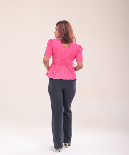 Back view of pink peplum top with side zipper closure