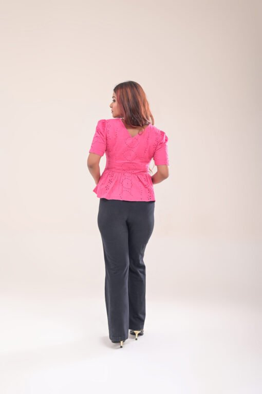 Back view of pink peplum top with side zipper closure